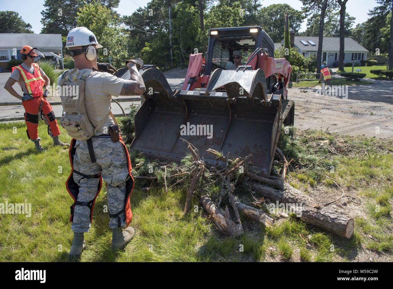Airmen from the Massachusetts Air National Guard's 102nd Civil Engineer Squadron mobilized to support recovery efforts in the wake of two tornadoes that touched down on Cape Cod on July 23, 2019, July 25, 2019. The Airmen cleared fallen trees and debris from roadways in the towns of Dennis and Harwich Massachusetts. Image courtesy Tech. Sgt. Thomas Swanson/102nd Intelligence Wing. () Stock Photo