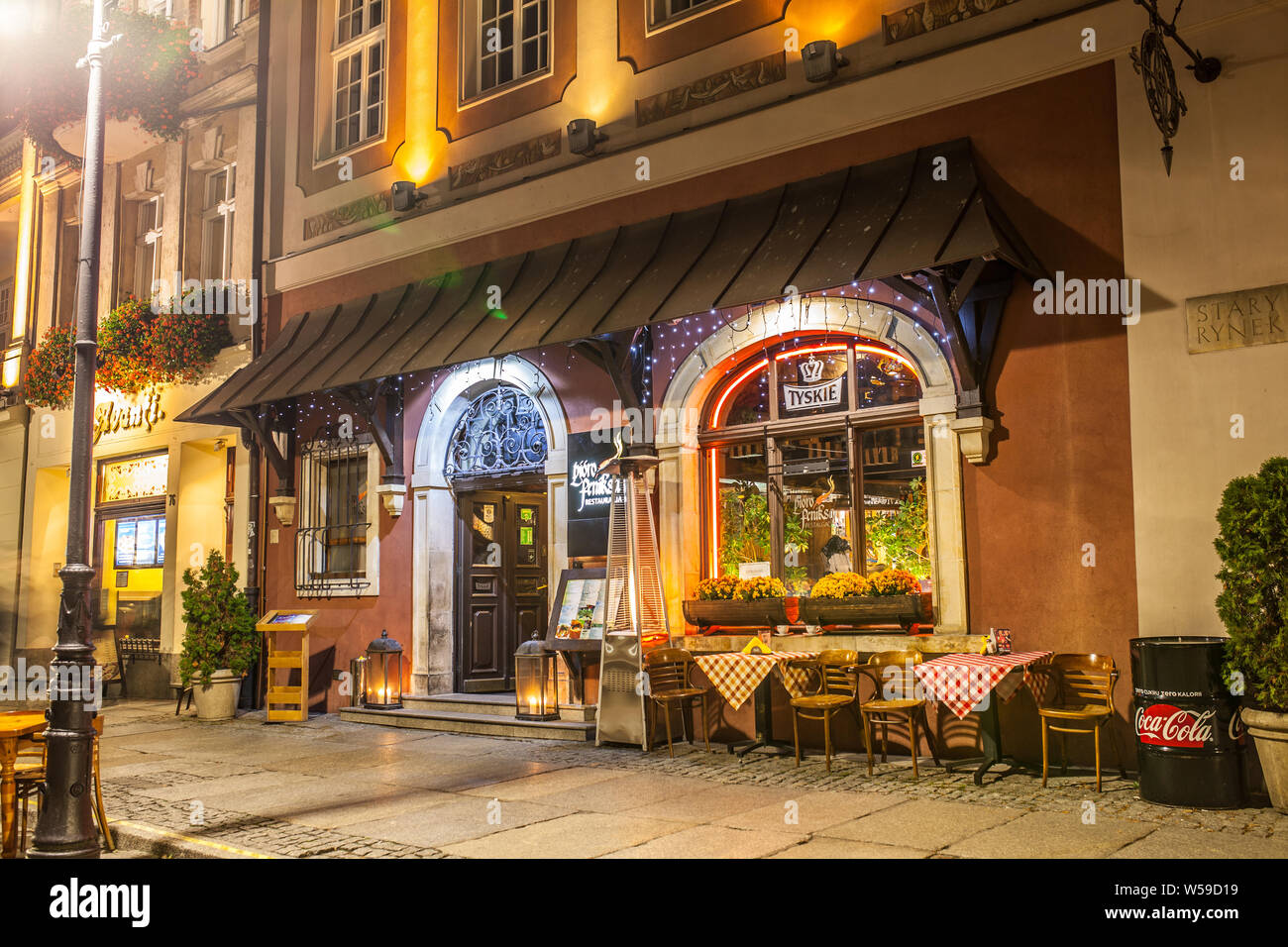 Poznan, Poland, Nov 2017: old Market Square at night, restaurant, bar ...