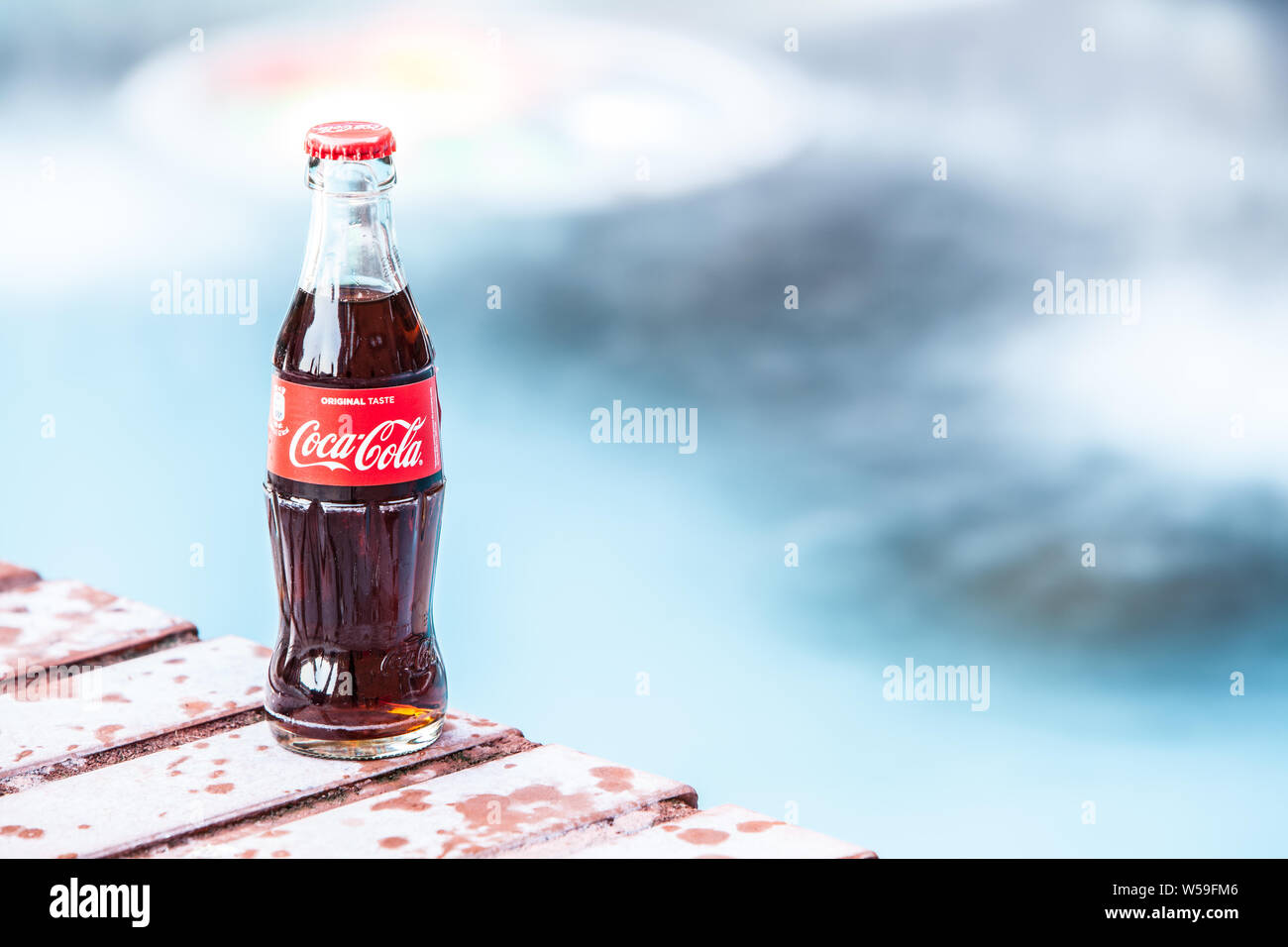 Classic Coca Cola bottle, Coca-Cola Company is the most popular market leader carbonated soft drink, winter, Stock Photo