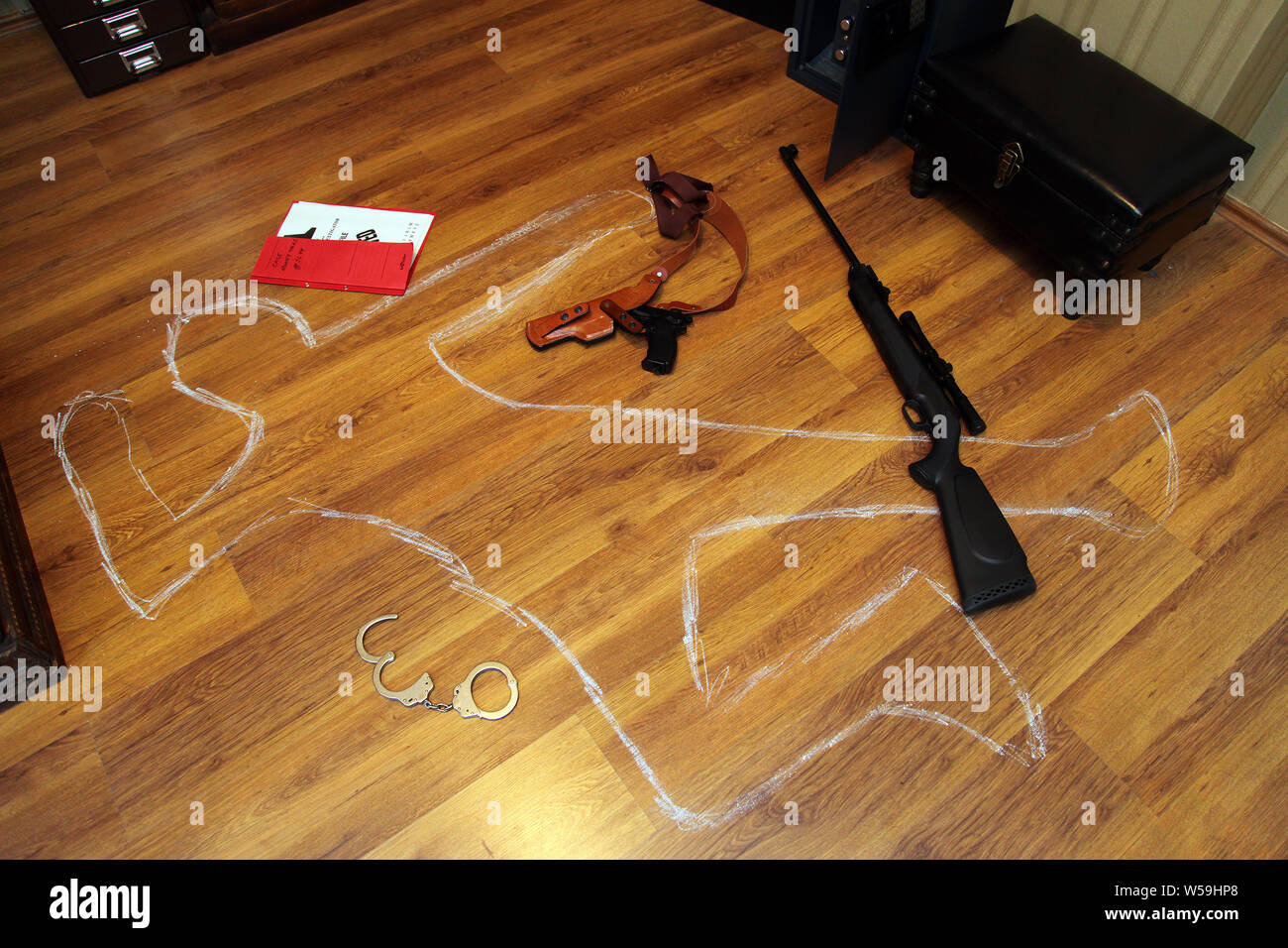 Gun, handcuffs and secret files in the crime scene Stock Photo