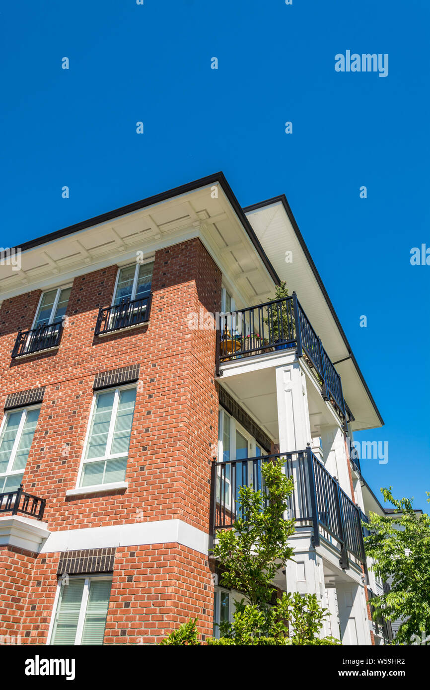 The corner of brand new apartment building on blue sky background Stock ...