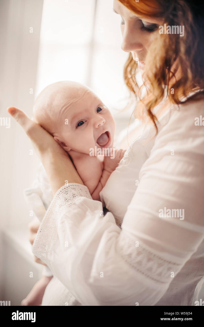 A young girl, mother in the hospital with a newborn. The concept of care and care for newborns Stock Photo
