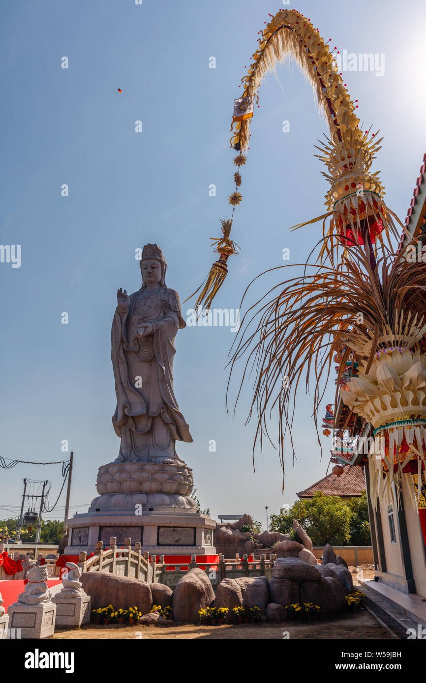 Statue of Tianhou Mazu, Chinese sea goddess at Vihara Satya Dharma, Chinese Buddhist temple. Penjor for Galungan. Benoa port, Bali, Indonesia. Stock Photo