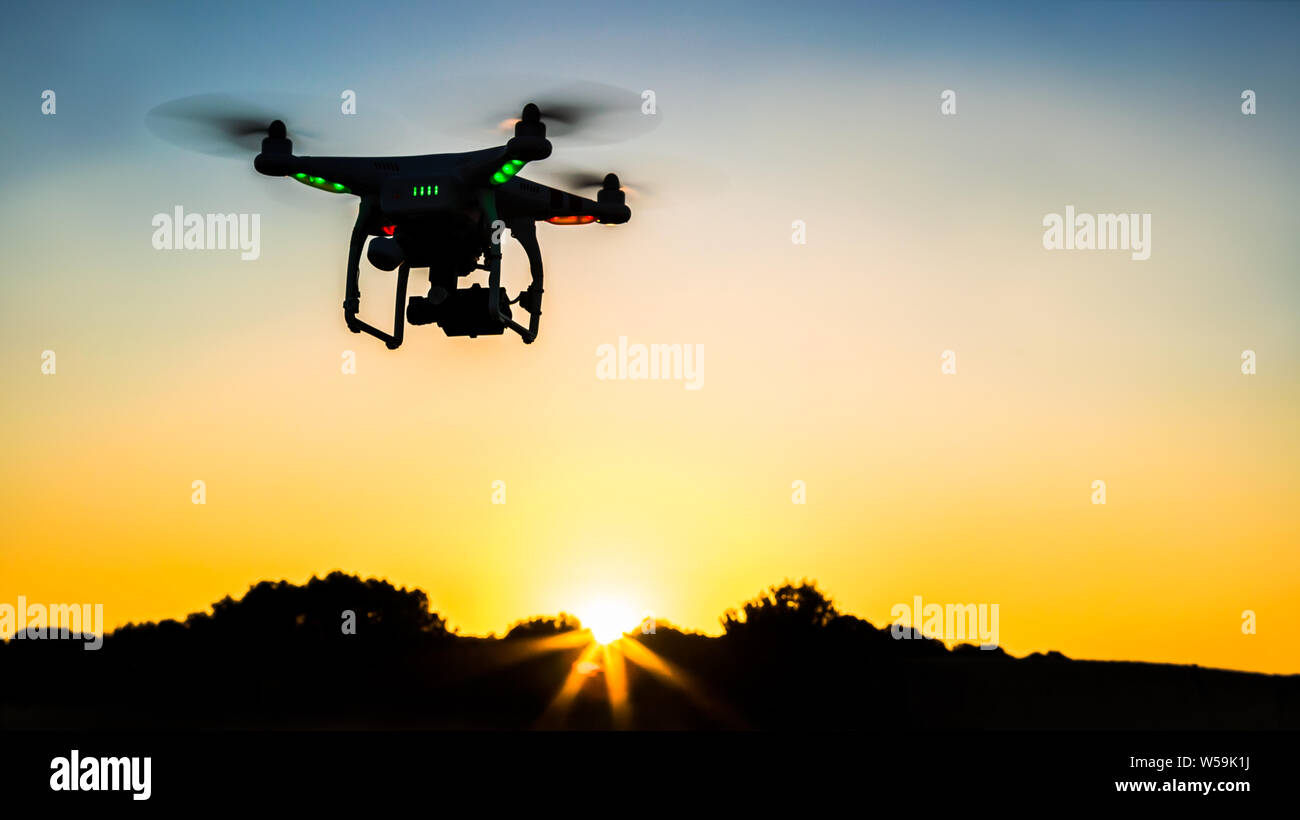 Aerial view of drone flying with a digital camera over a field with sunset  sky. Rural countryside landscape in Spain. Beautiful scenery Stock Photo -  Alamy