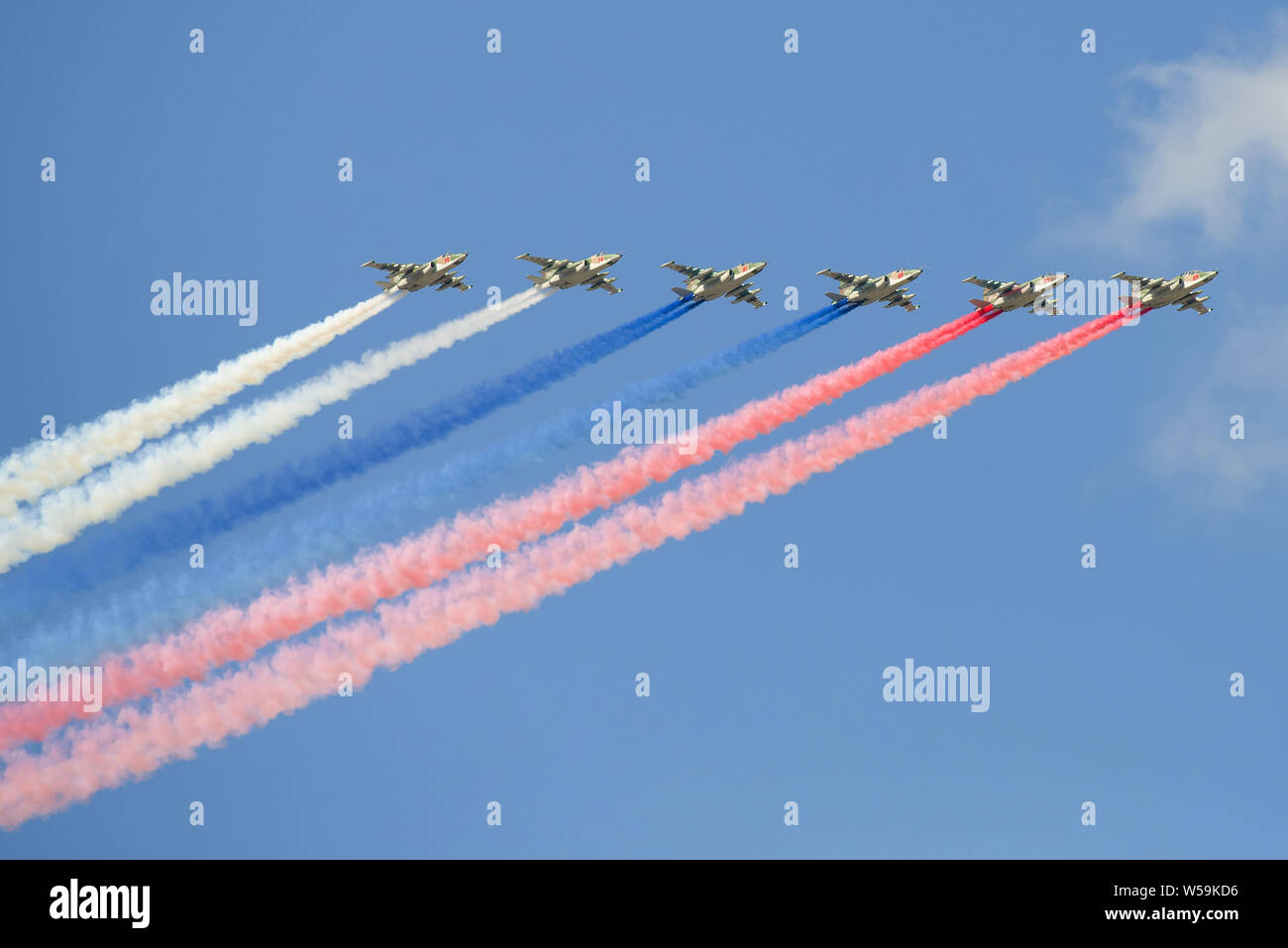 SAINT-PETERSBURG, RUSSIA - JULY 25, 2018: Russian Su-25 attack aircraft with smoke colors of the Russian flag. Fragment of the dress rehearsal of the Stock Photo