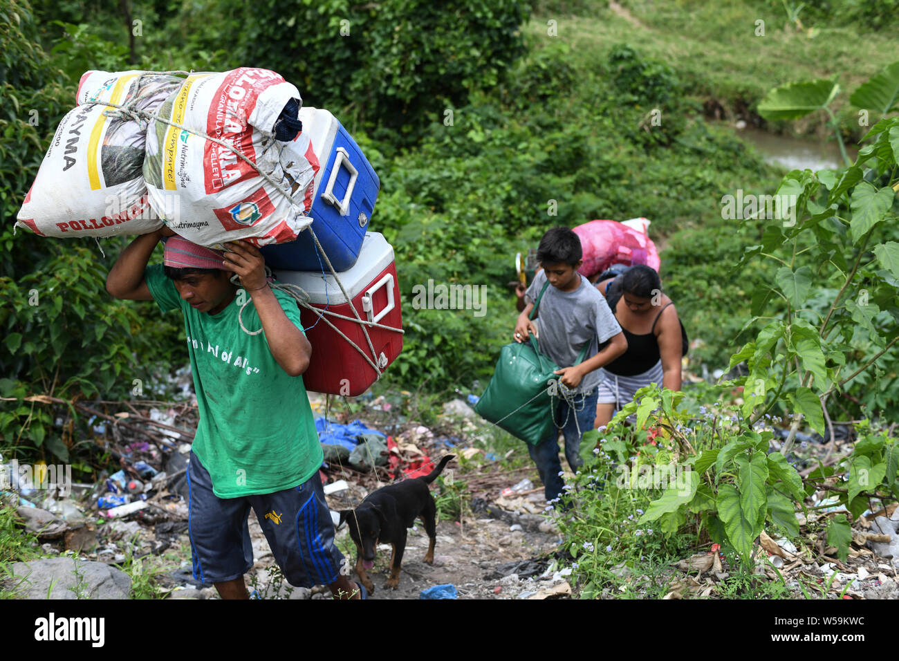 July 25, 2019, Talisman, Chiapas, Mexico: With the help of porters, Central American families and their pets cross into Mexican territory on Thursday, even as Guatemala signed a treaty with the US designating it a 'safe'' country for migrants. Credit: Miguel Juarez Lugo/ZUMA Wire/Alamy Live News Stock Photo