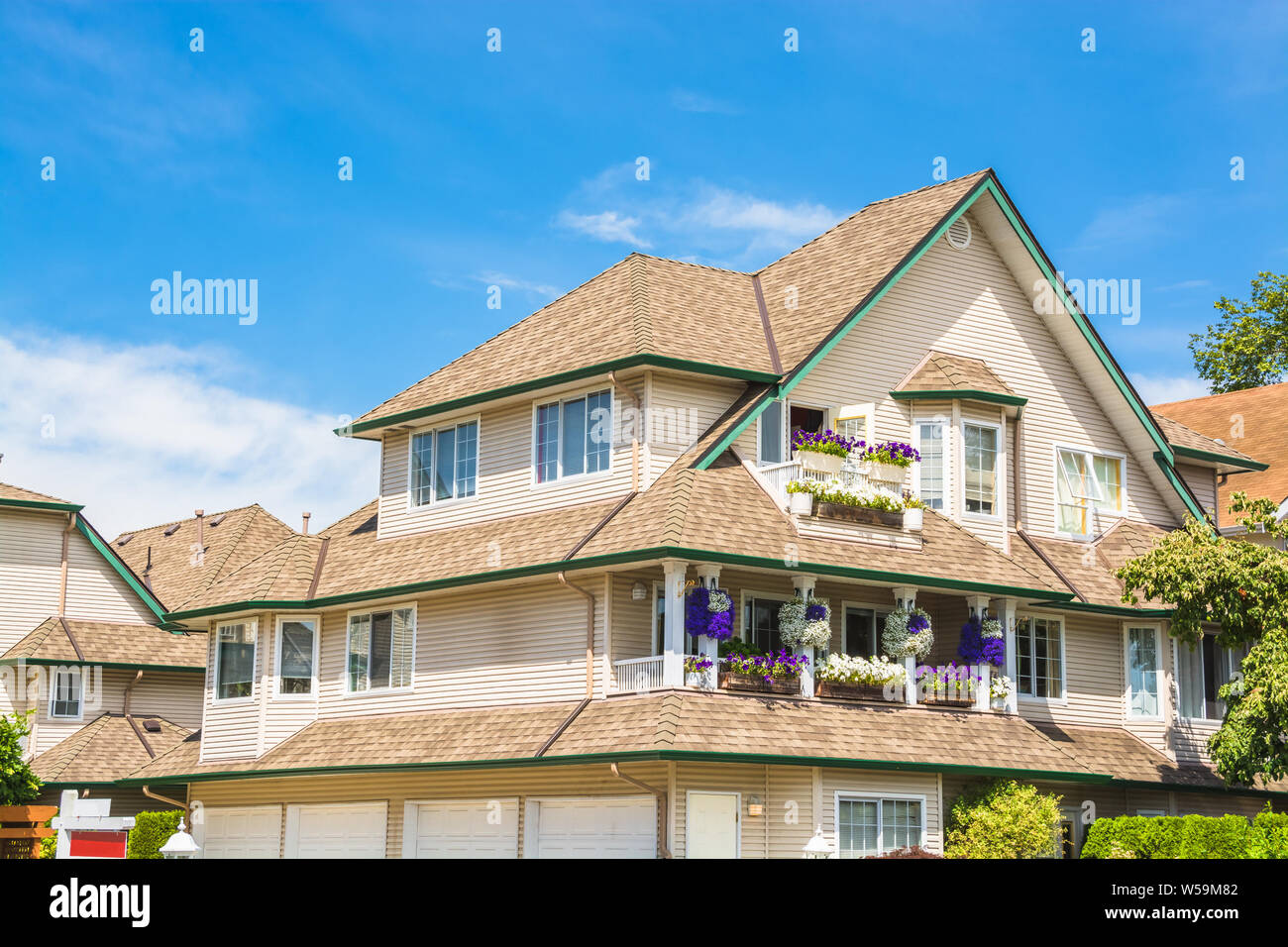 Top of big luxury residential house on blue sky background Stock Photo ...