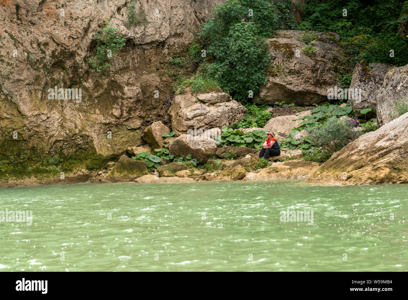 Pinarbasi, Kastamonu/Turkey-June 30 2019: Girl sitting and enjoying water near  Ilica waterfalls Stock Photo