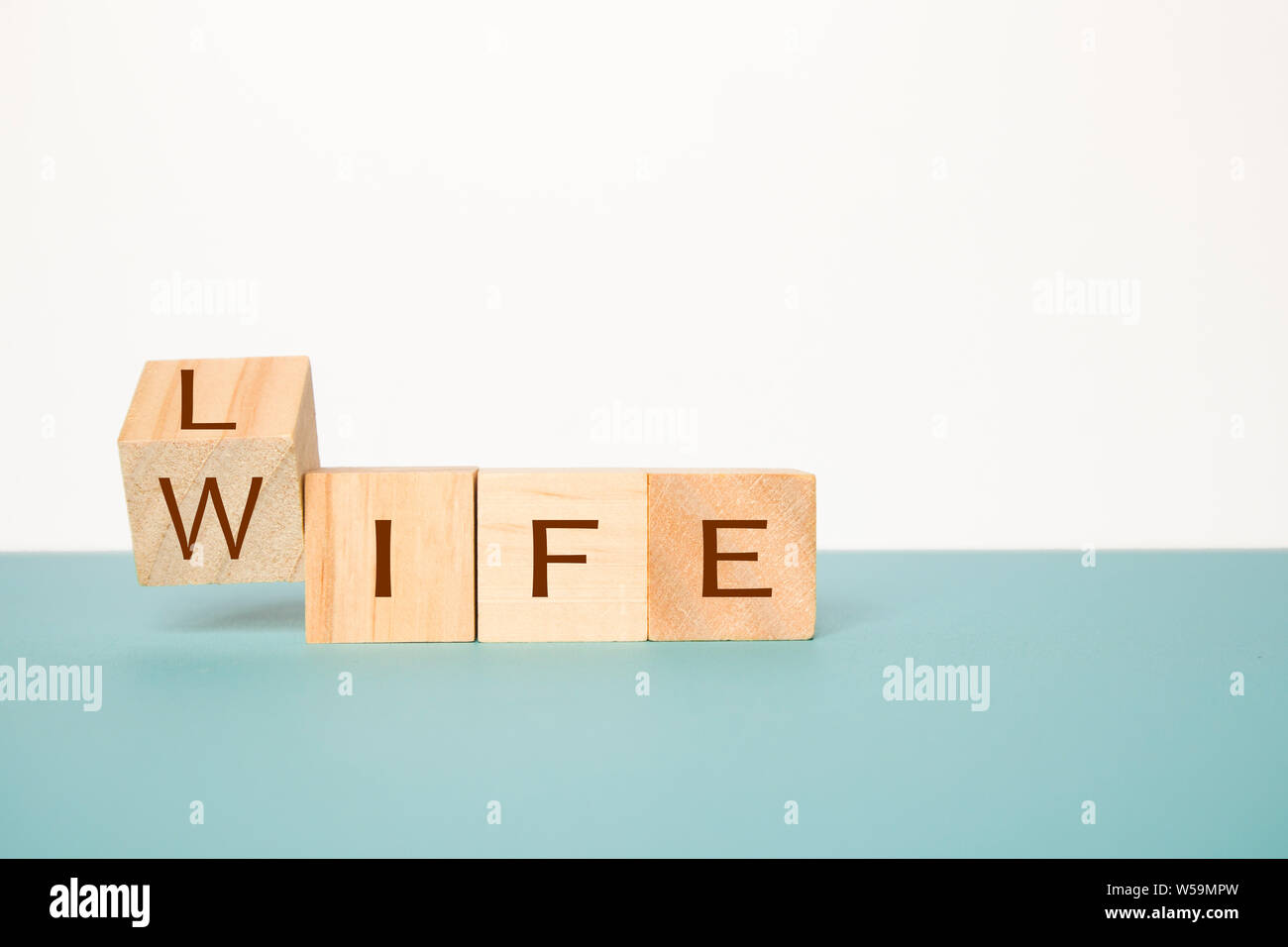 Flipping One Wooden Cube To Change The Word Life To Wife On