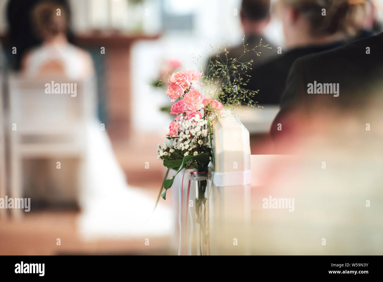 Dainty pink posy of flowers on a wedding chair Stock Photo