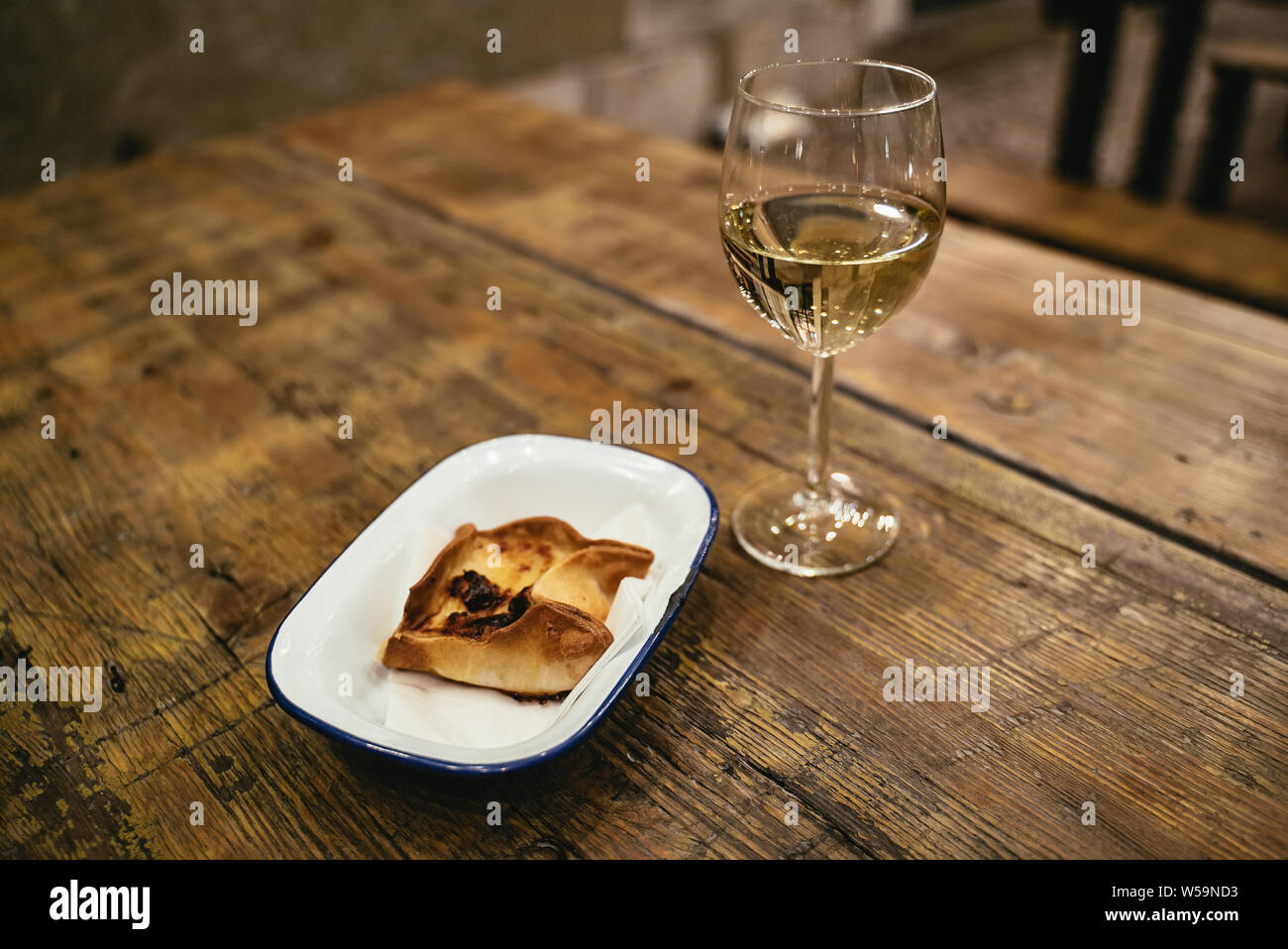 Baked pastry dessert and glass of white wine Stock Photo Alamy