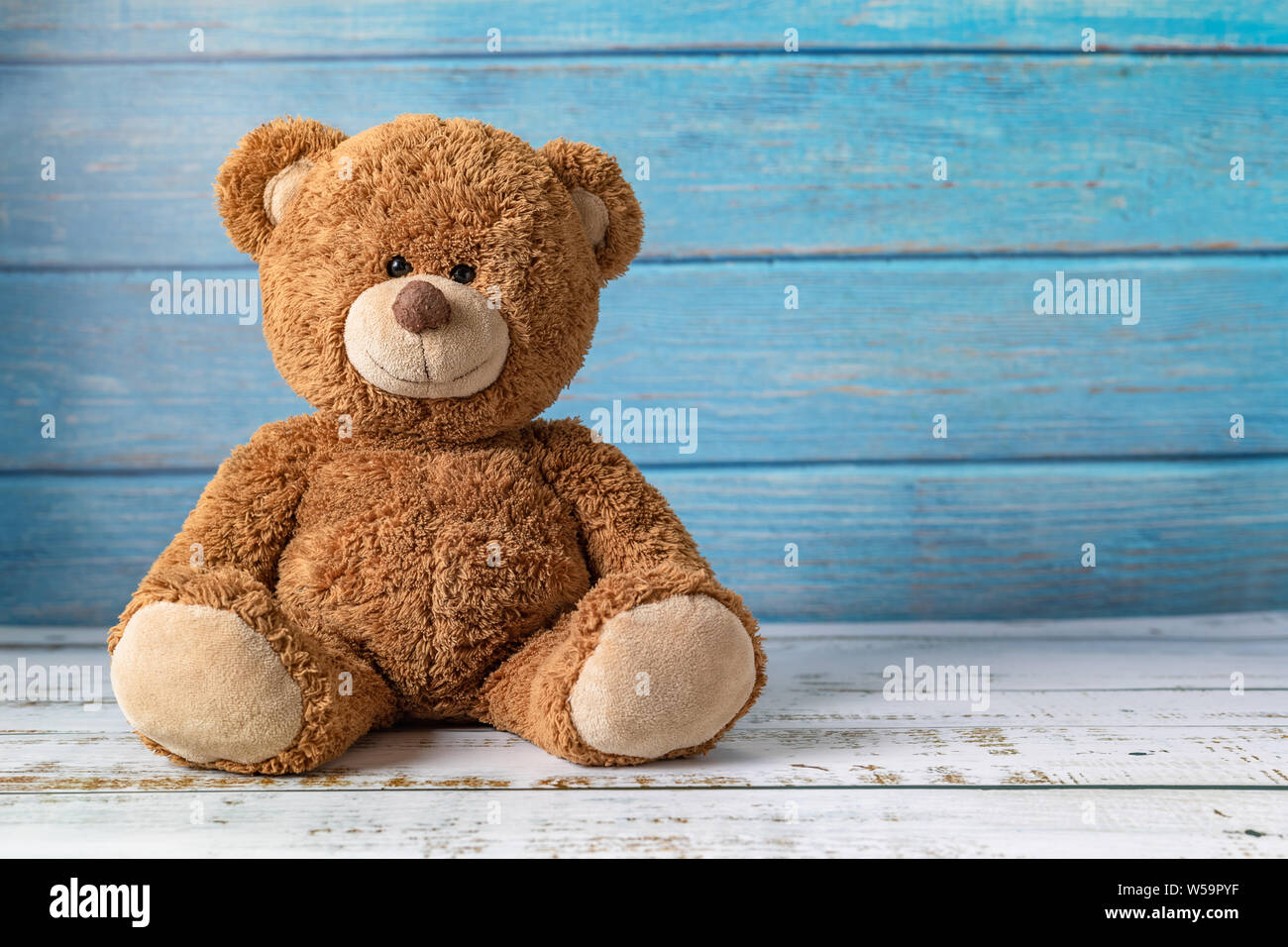Cute teddy bear with copy space on blue color wood background Stock ...