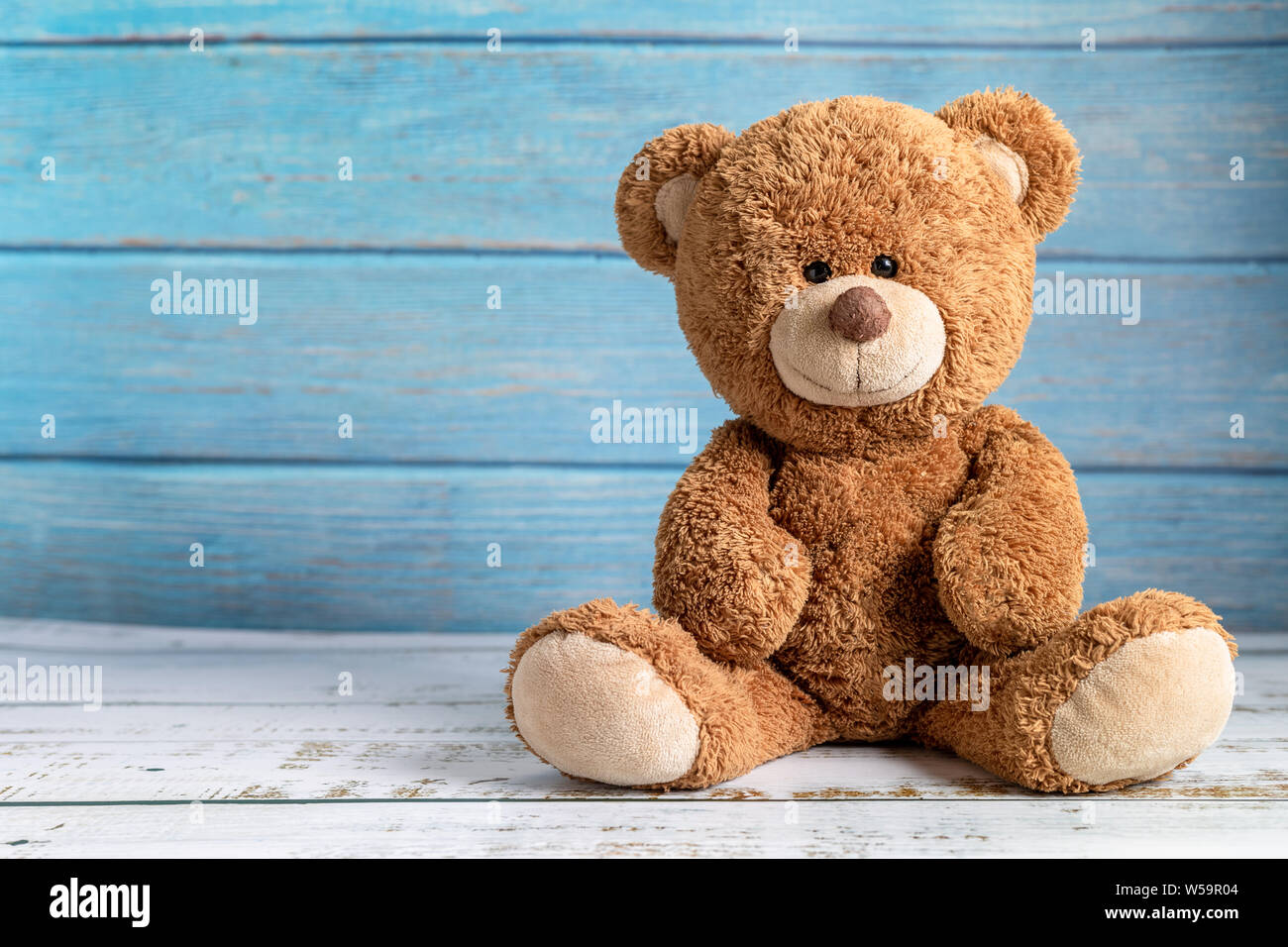 Cute teddy bear with copy space on blue color wood background Stock ...
