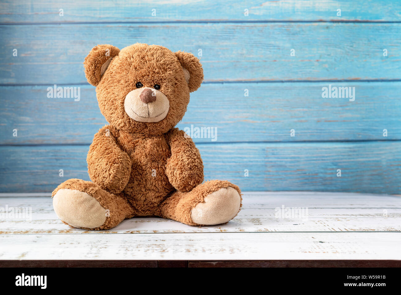 Cute teddy bear with copy space on blue color wood background Stock ...