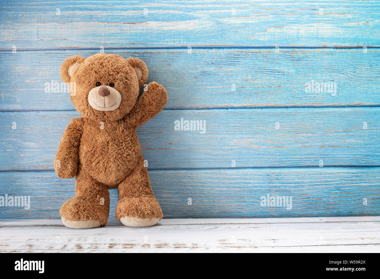 Cute teddy bear with copy space on blue color wood background Stock ...