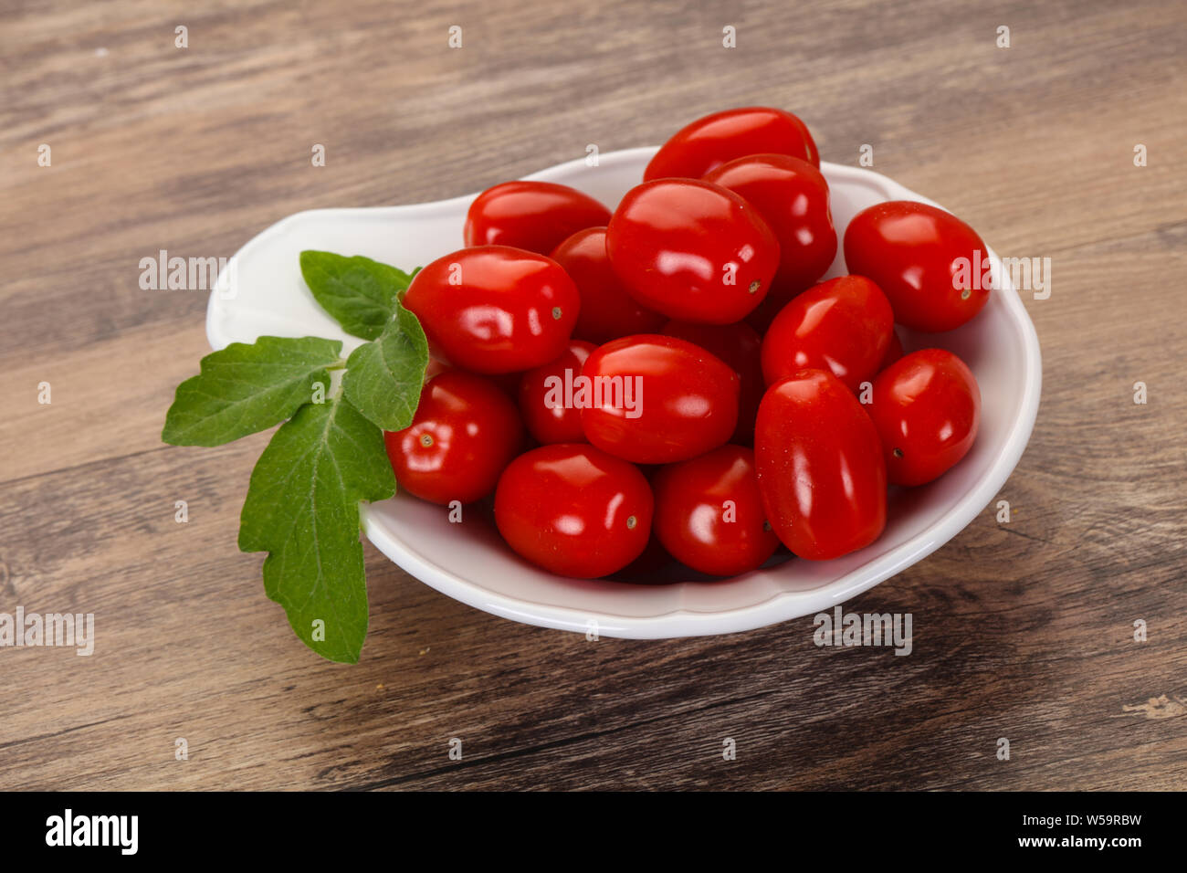 Sweet Red cherry tomatoes in the bowl Stock Photo - Alamy