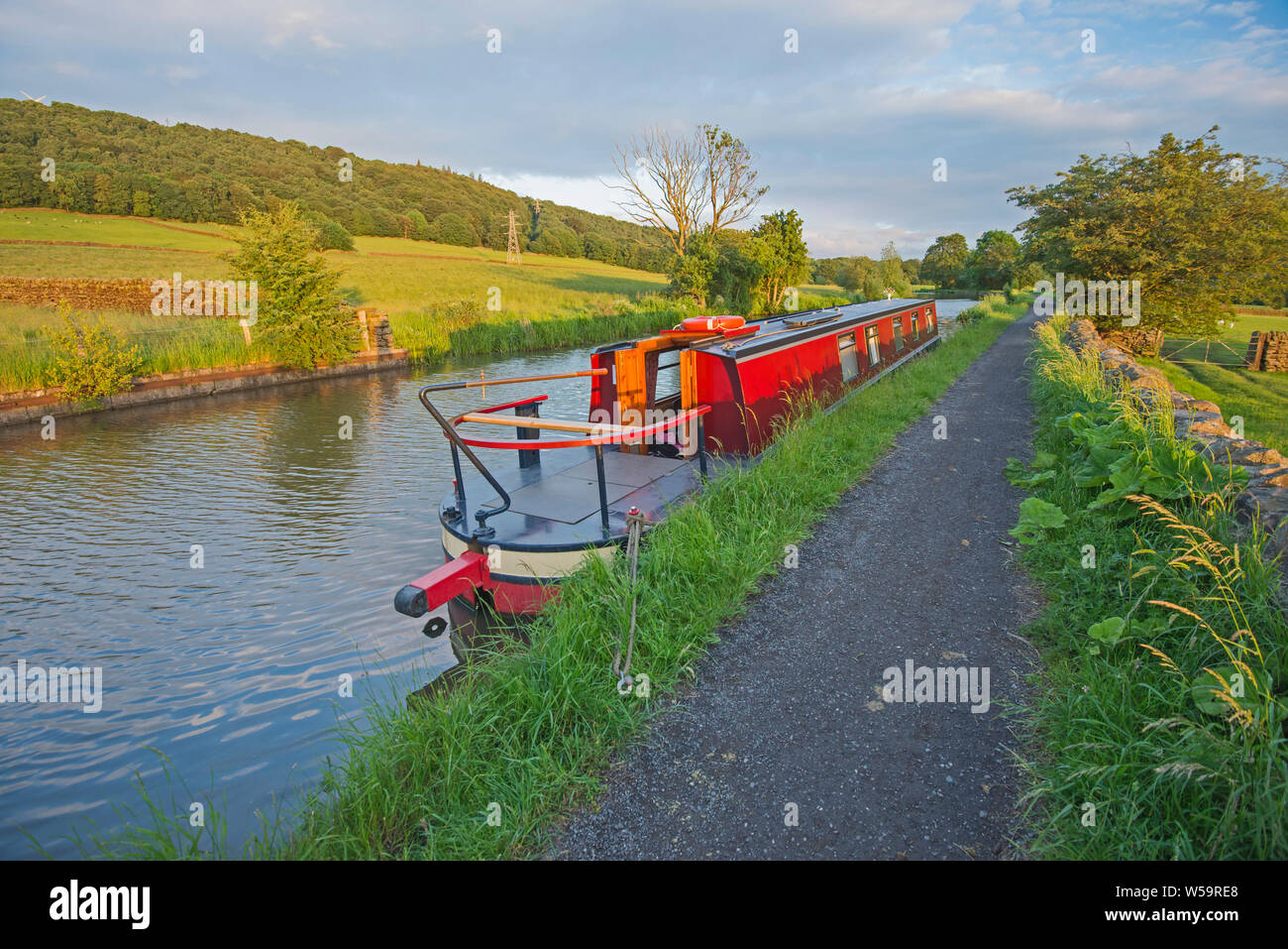 Narrowboat moored up in English rural countryside scenery on British waterway canal Stock Photo