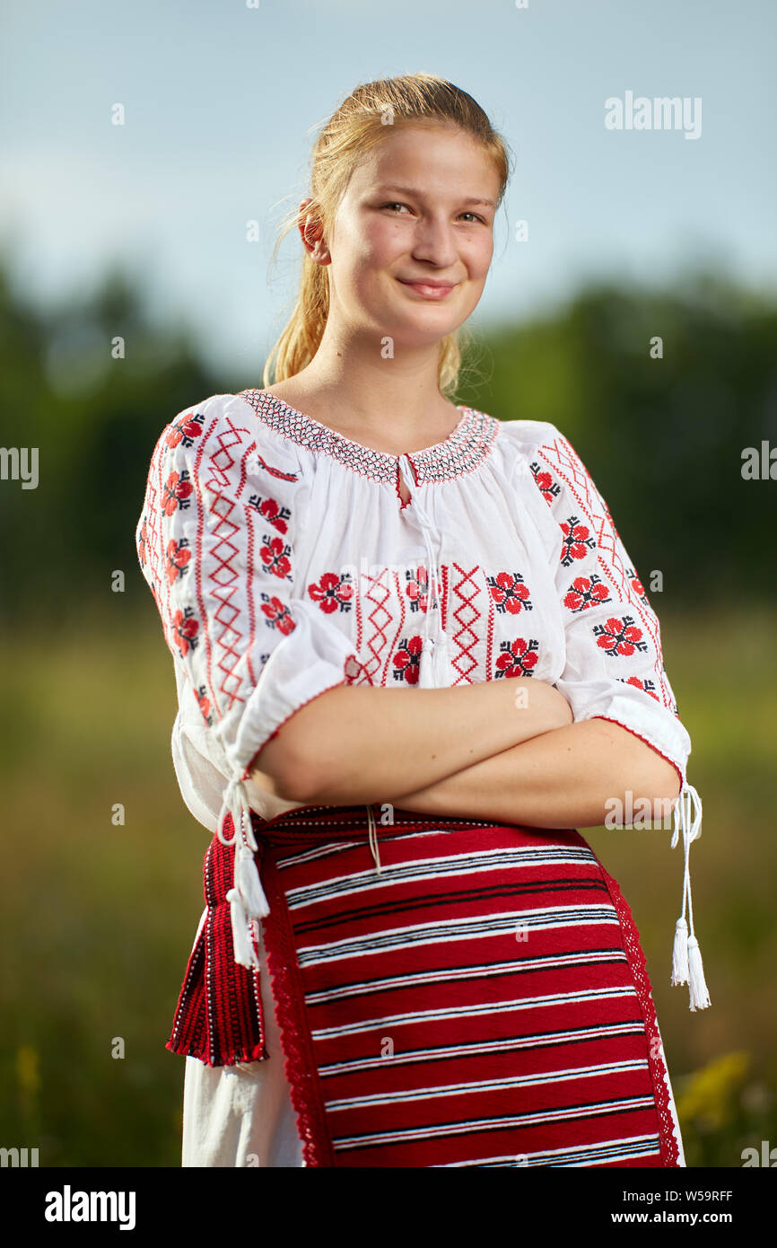 Portrait of a Romanian girl in traditional costume in an oak forest Stock Photo