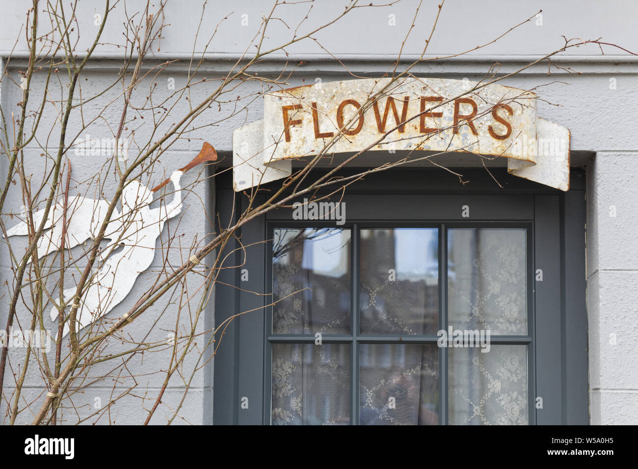 sign for flower shop and a trumpeting angel Stock Photo