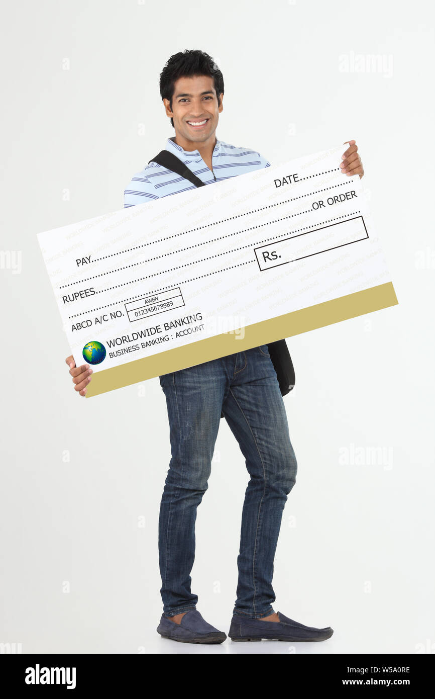 College student showing bank cheque and smiling Stock Photo