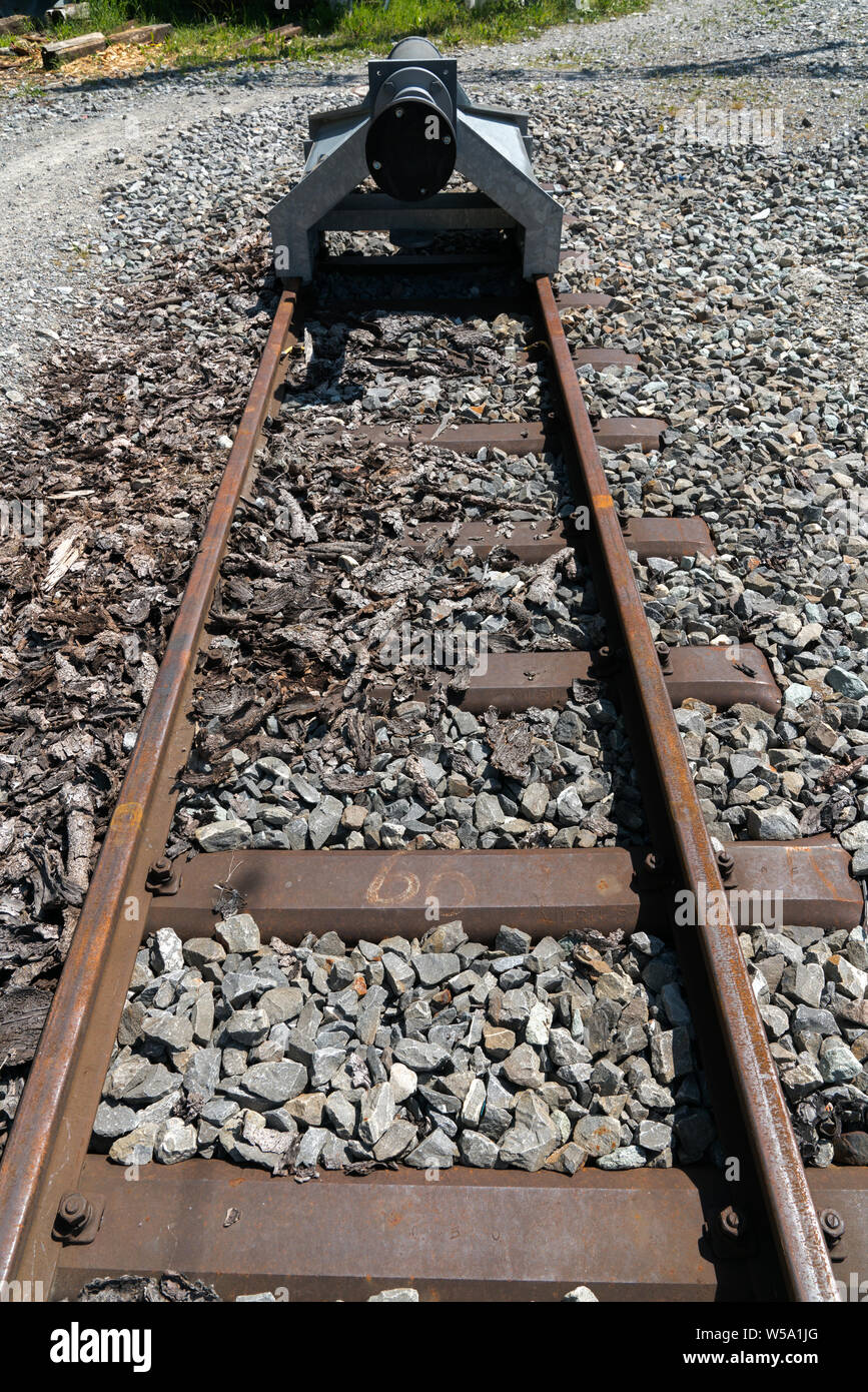close up view of the end of narrow gauge railroad track with a buffer stop Stock Photo