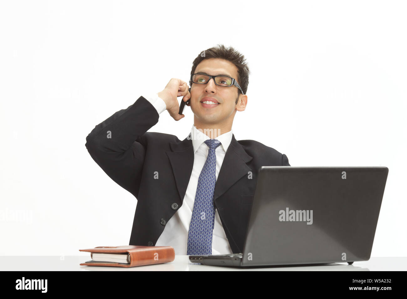 Businessman talking on a mobile phone and smiling Stock Photo