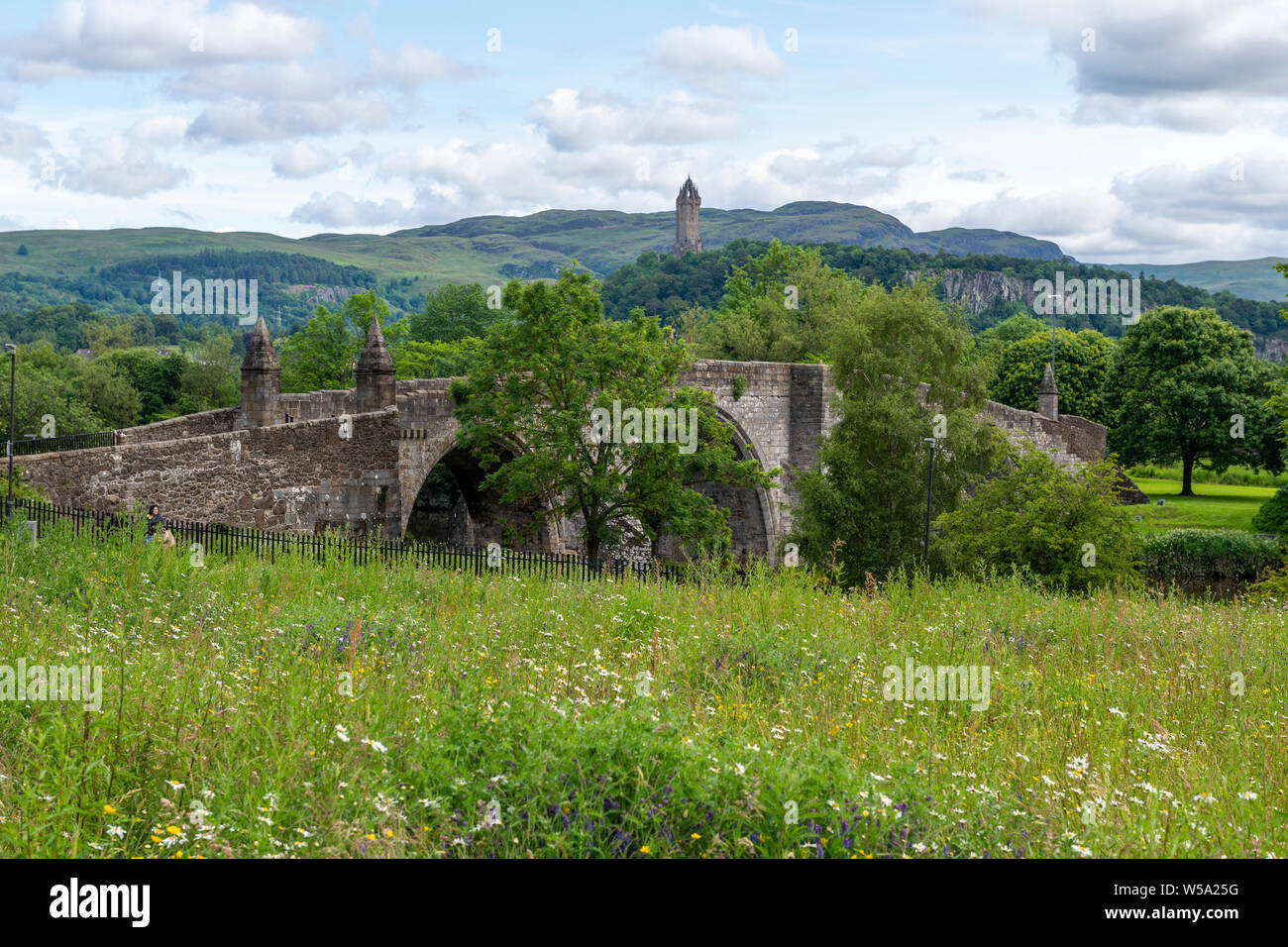 Old Stirling Bridge on the River Forth with Wallace Monument in background at Stirling, Scotland, UK Stock Photo
