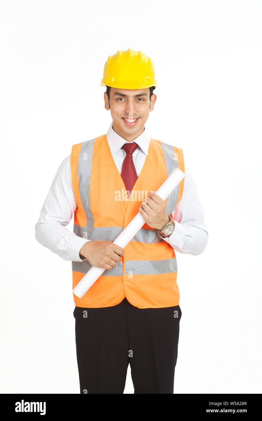 Male architect holding a blueprint and smiling Stock Photo