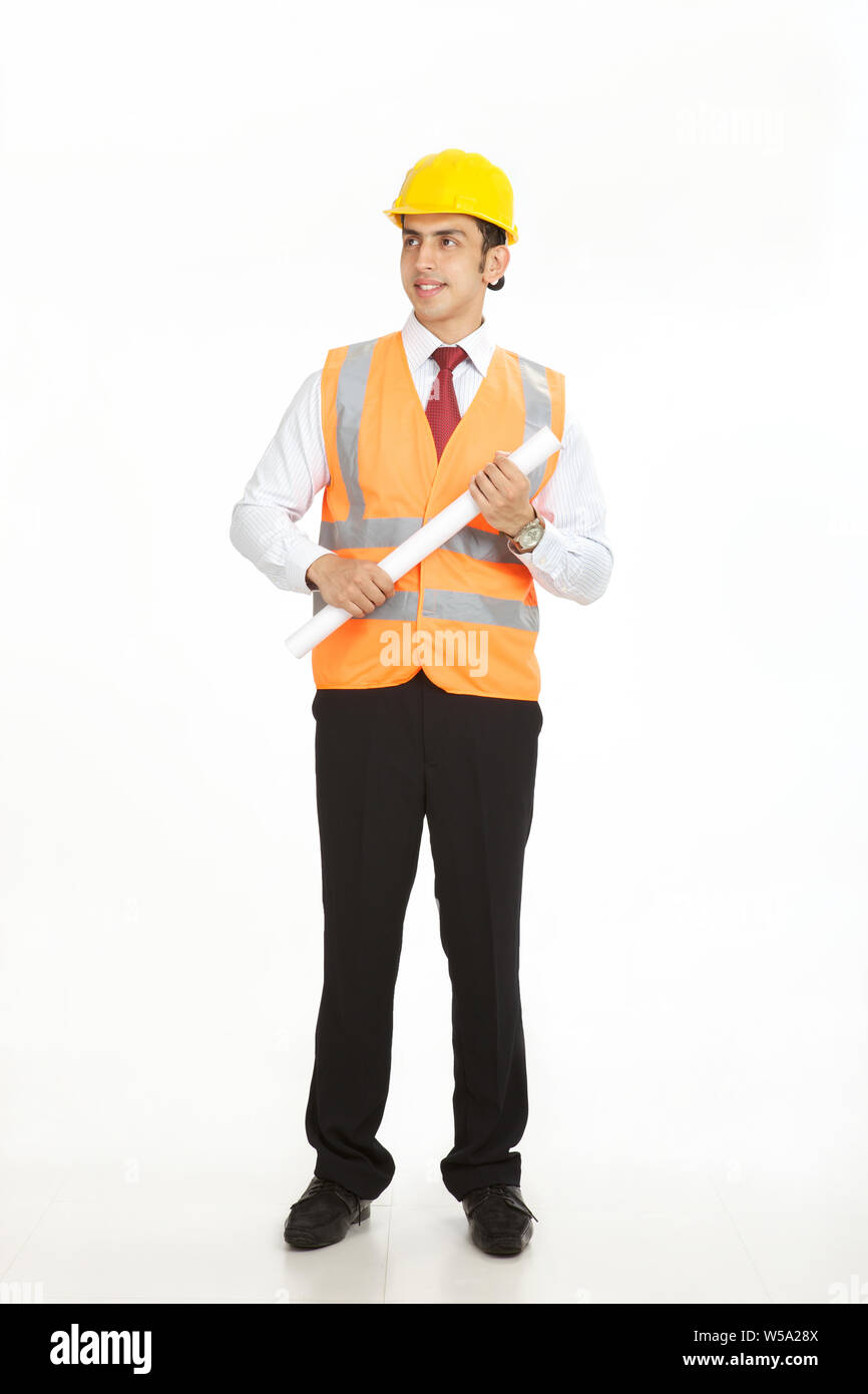 Male architect standing and holding a blueprint Stock Photo