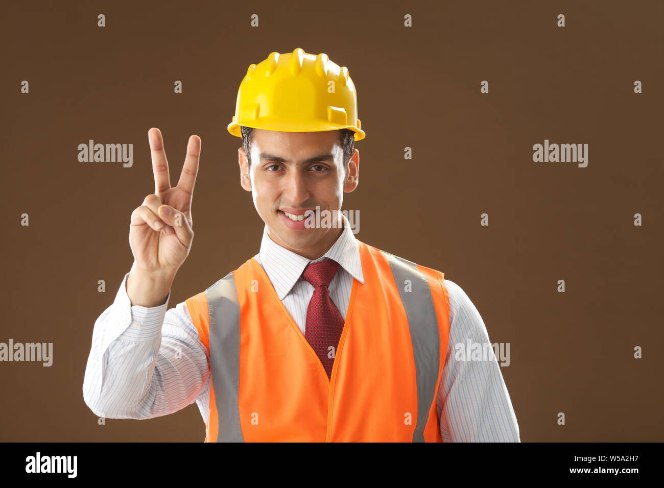 Portrait of an architect showing v sign Stock Photo