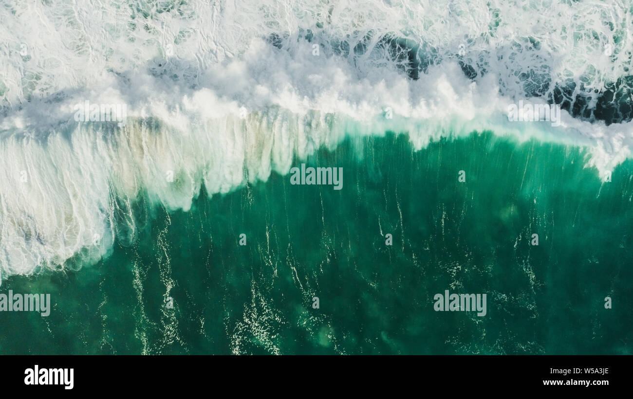 Aerial wave background. Drone shot directly from above, green turquoise color, huge waves. Empty space Stock Photo