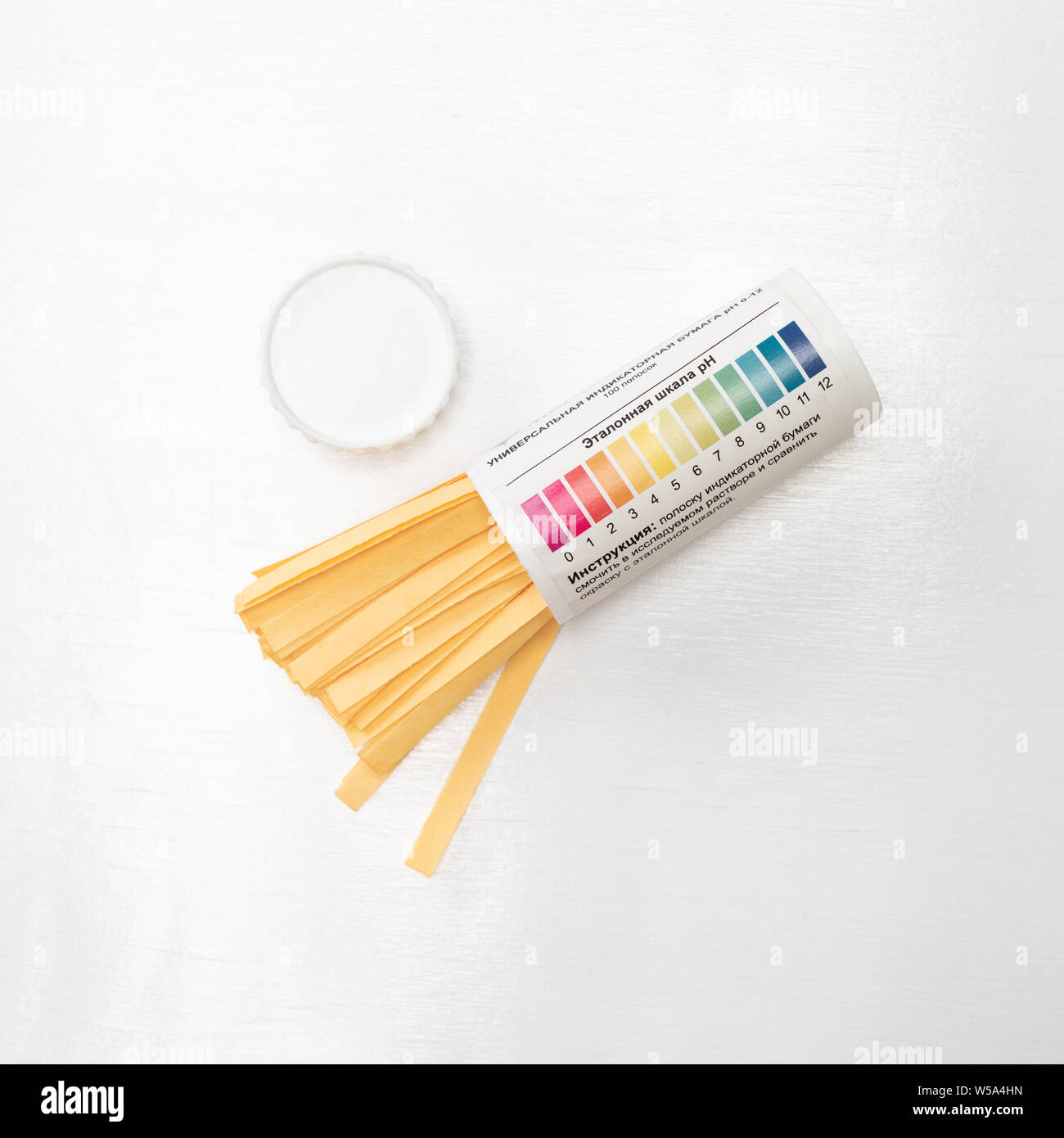 Pack of litmus test paper and color samples on white. Universal indicator paper. Checking the ph Stock Photo