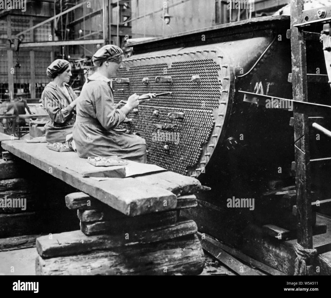 WW1 Women working on a condenser tube in a factory Stock Photo - Alamy