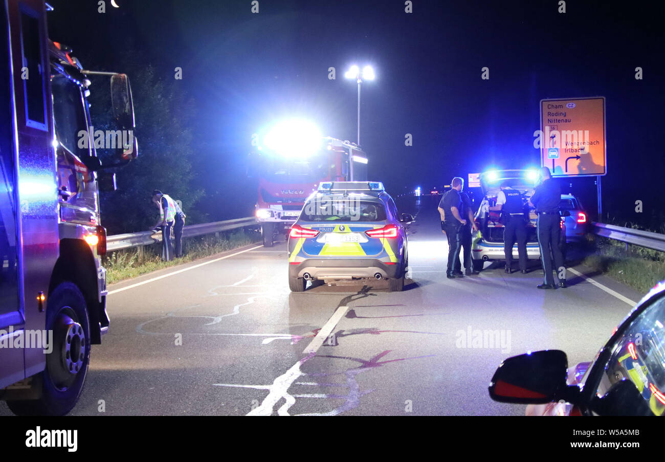 Wenzenbach, Germany. 27th July, 2019. Police cars are parked on the B16 near Wenzenbach. To stop a car driver who fled from the police near Regensburg, officers had fired several shots at his car. Two policemen were slightly injured in the pursuit of the car. (to dpa 'Car driver flees from police - officials fire shots') Credit: Alexander Auer/dpa/Alamy Live News Stock Photo