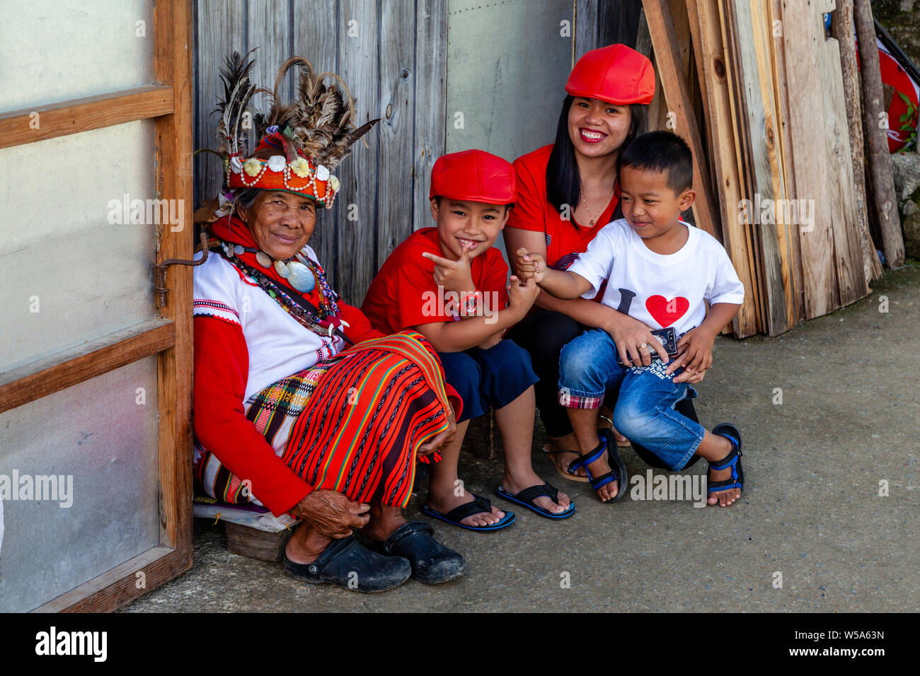 A Filipino Family Pose With An Ifugao Tribal Woman, Banaue, Luzon, The philippines Stock Photo