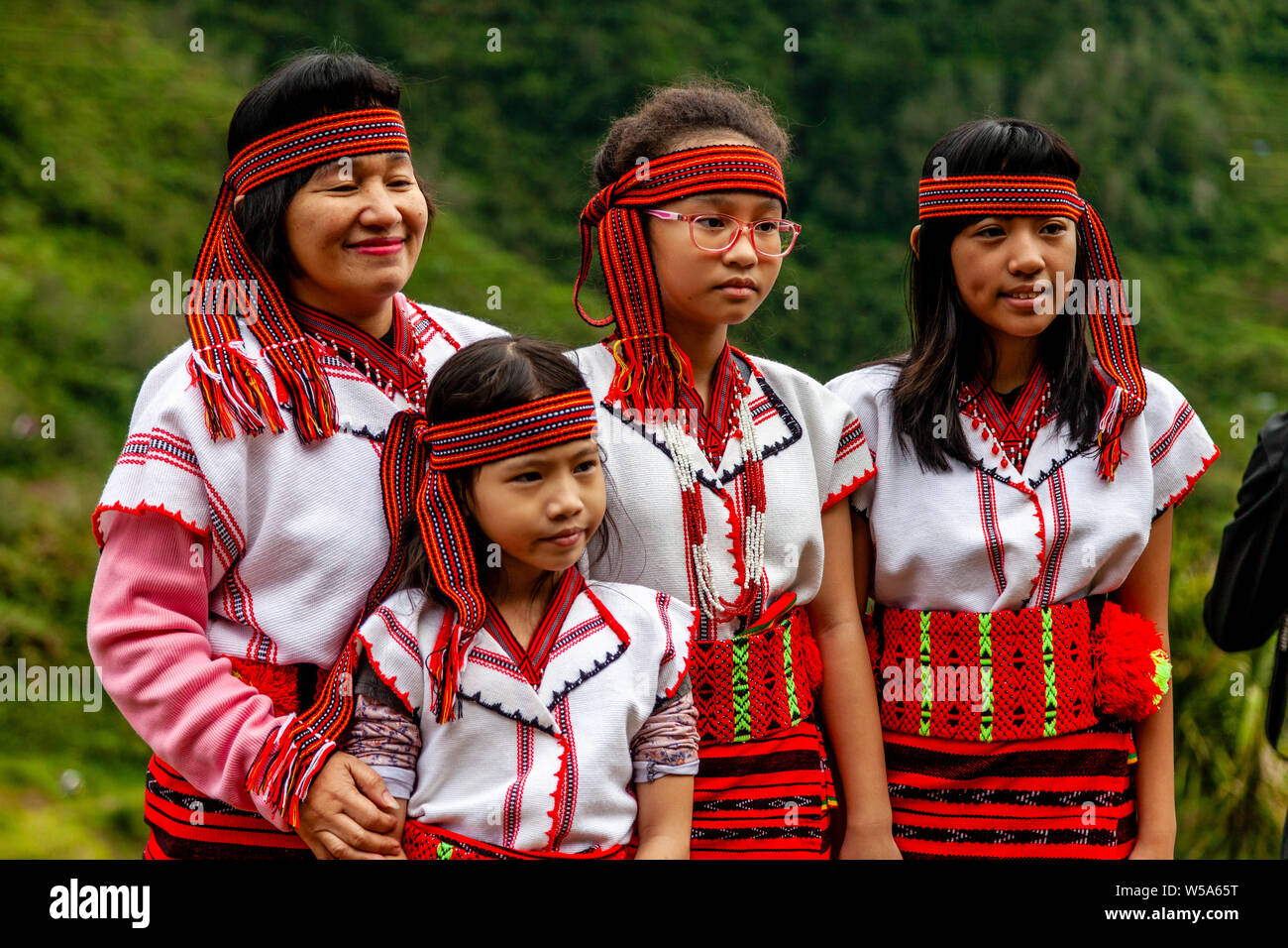 A Filipino Family Pose For Photos Wearing Traditional Ifugao Tribal Costumes, Banaue, Luzon, The Philippines Stock Photo