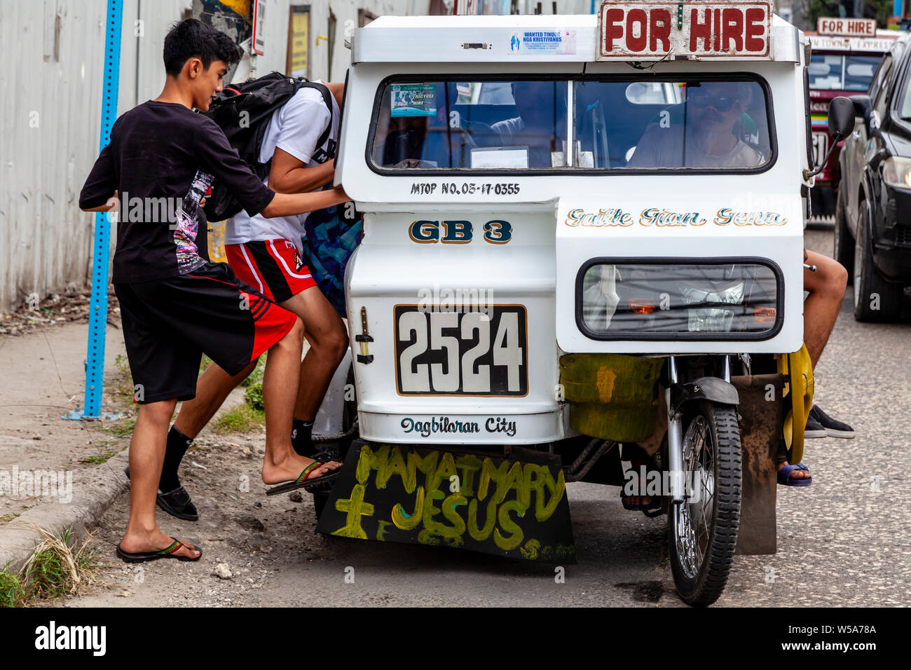 Local People Getting Into A Tricycle, Tagbilaran City, Bohol, The Philippines Stock Photo