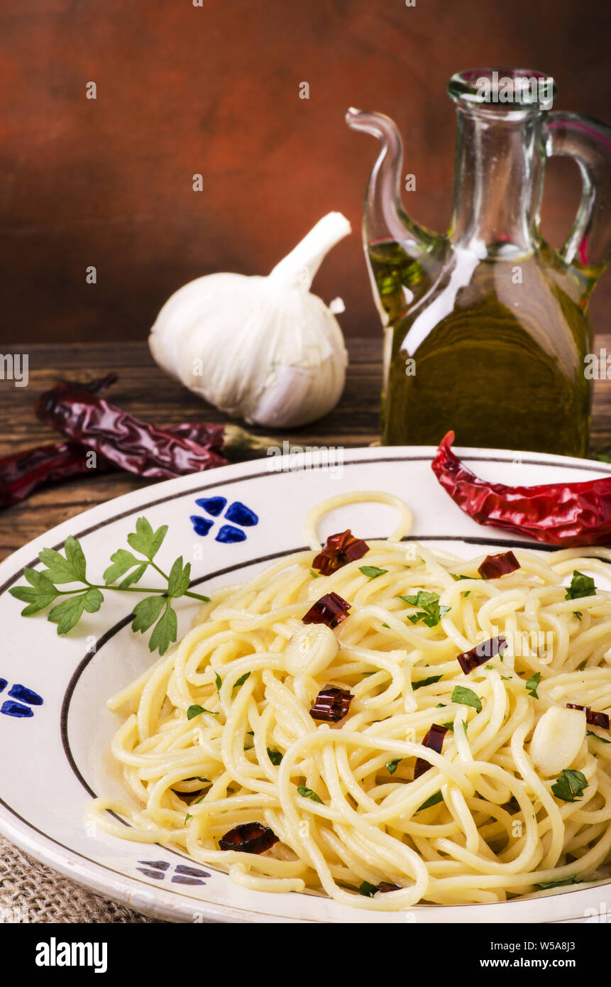 still life.Closeup of a plate with spaghetti cooked with olive oil, garlic and chili pepper, traditional Italian recipe Stock Photo
