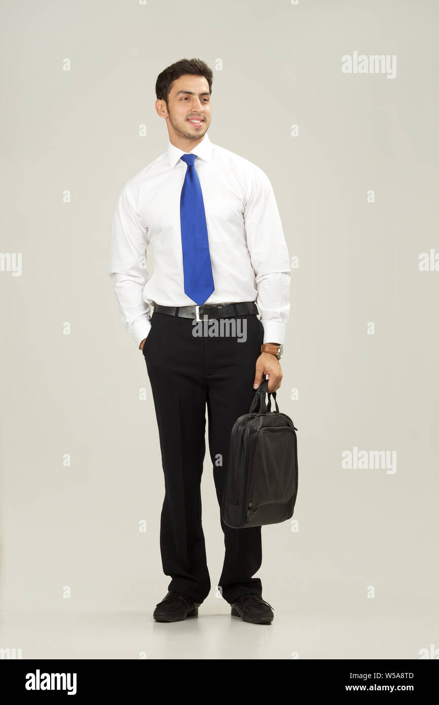 Businessman walking with bag Stock Photo