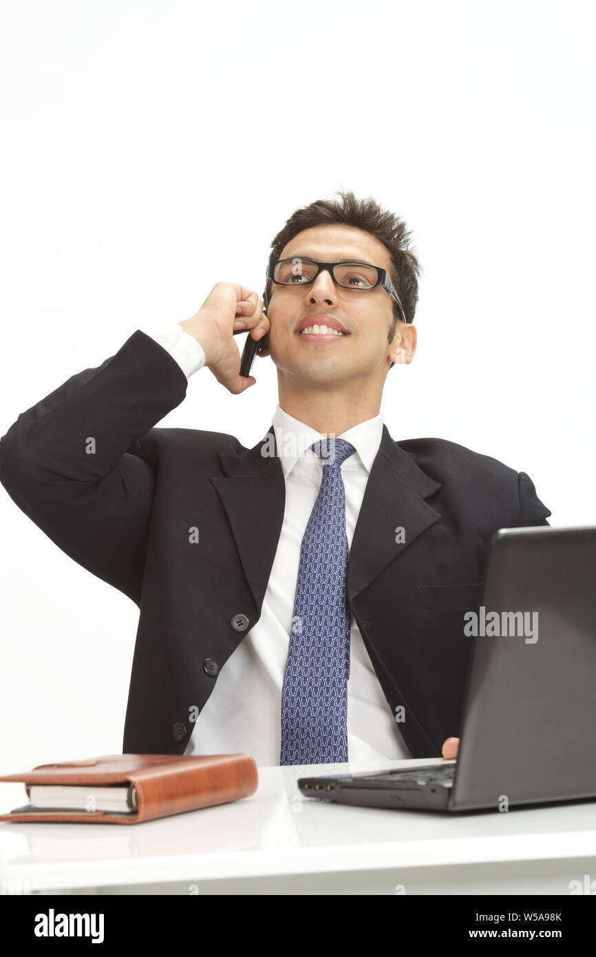 Businessman talking on a mobile phone and smiling Stock Photo