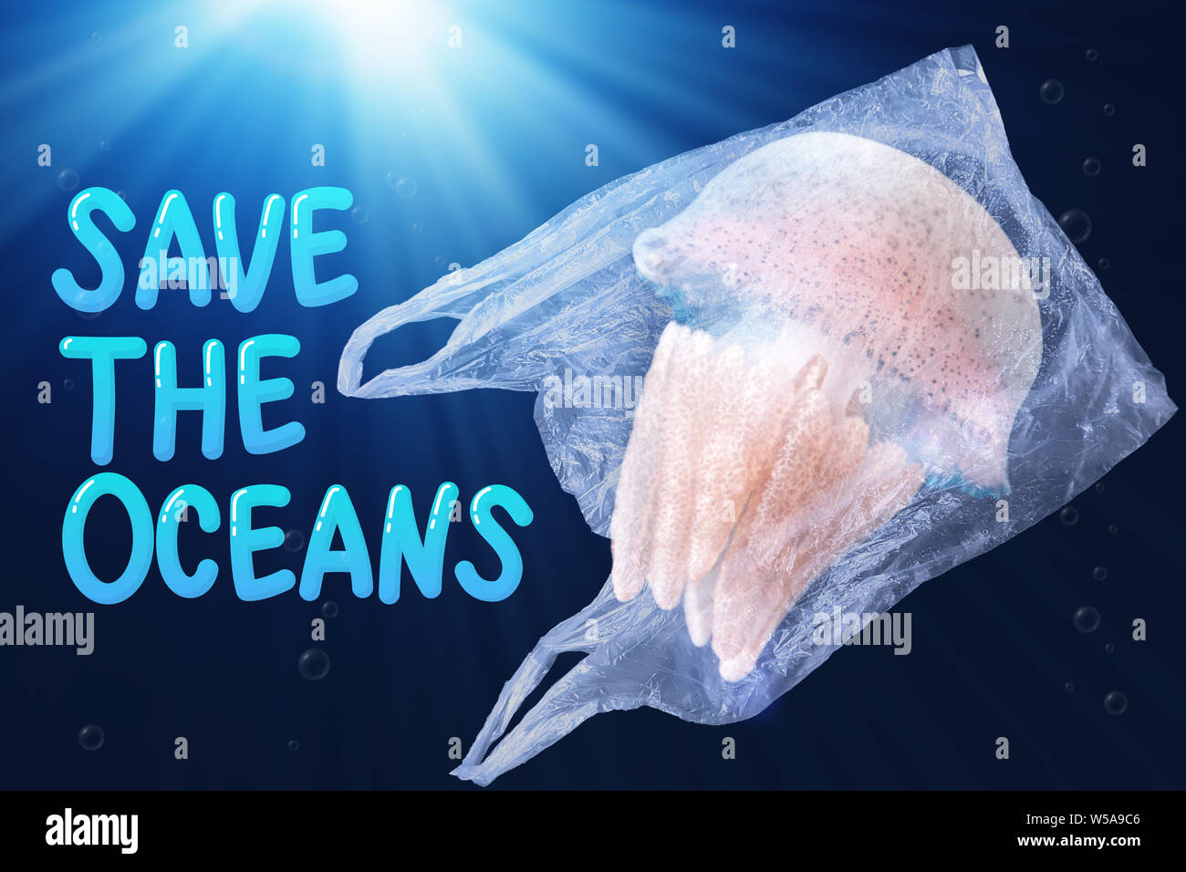 plastic pollution in ocean environmental problem concept.  jellyfish swim inside plastic bag floating in the ocean with text save the oceans Stock Photo