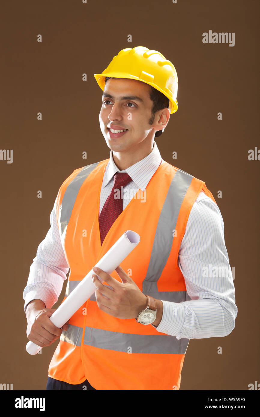 Male architect holding a blueprint Stock Photo