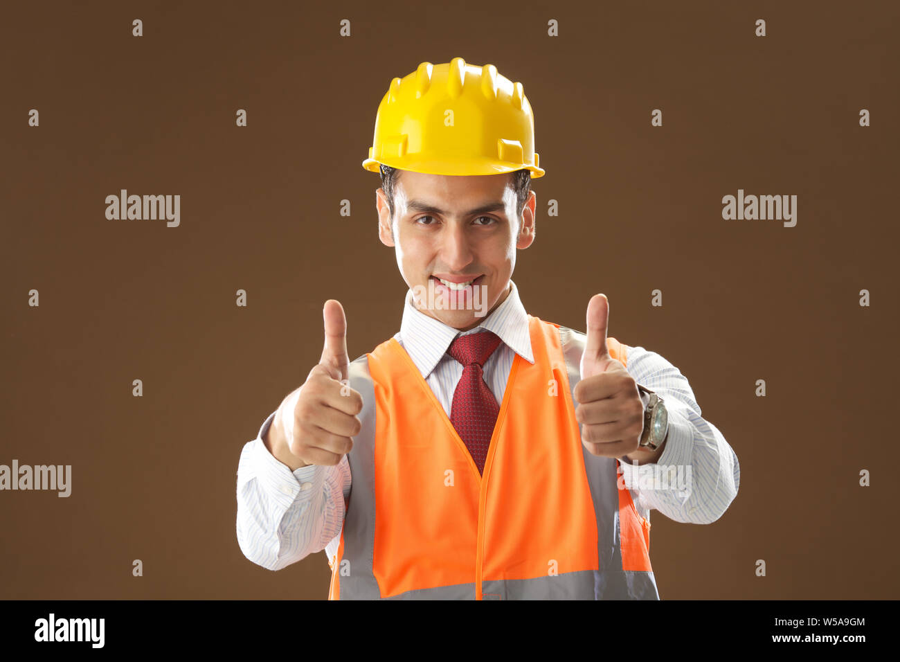 Portrait of a male architect showing thumbs up sign and smiling Stock Photo