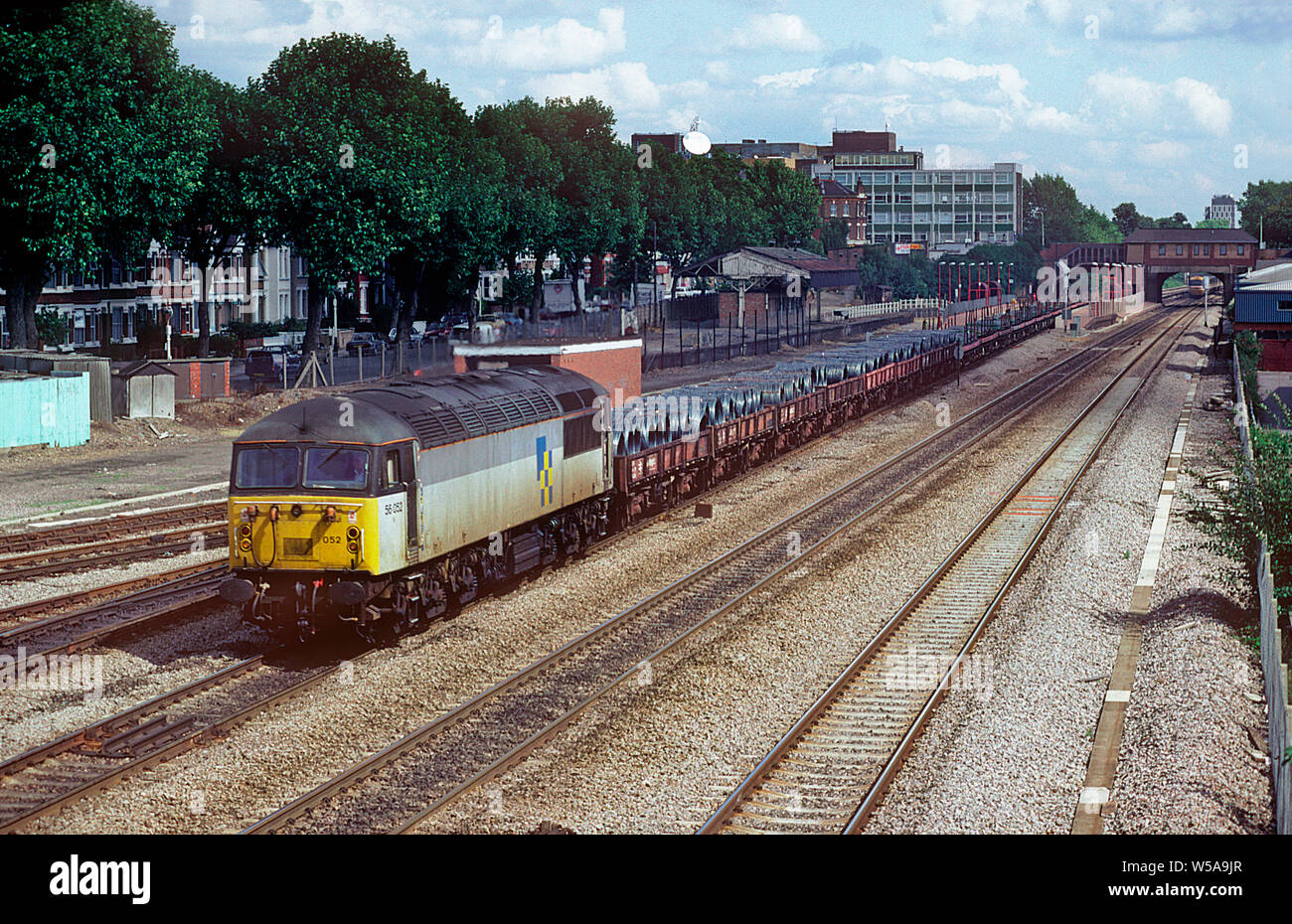 A class 56 diesel locomotive number 56052 working a freight train loaded with finished steel products at West Ealing on the 29th August 1992. Stock Photo
