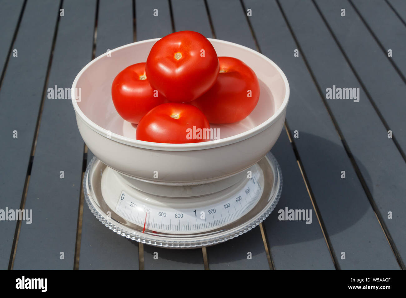 Measuring the weight of tomatoes on a scales Stock Photo Alamy