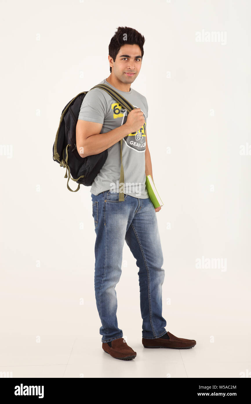 College student carrying backpack with a book Stock Photo Alamy