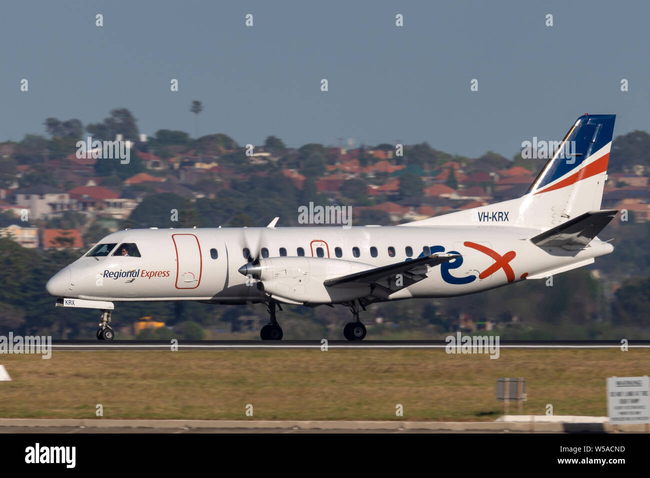 REX (Regional Express Airlines) Saab 340 twin engined regional commuter aircraft taking off from Sydney Airport. Stock Photo