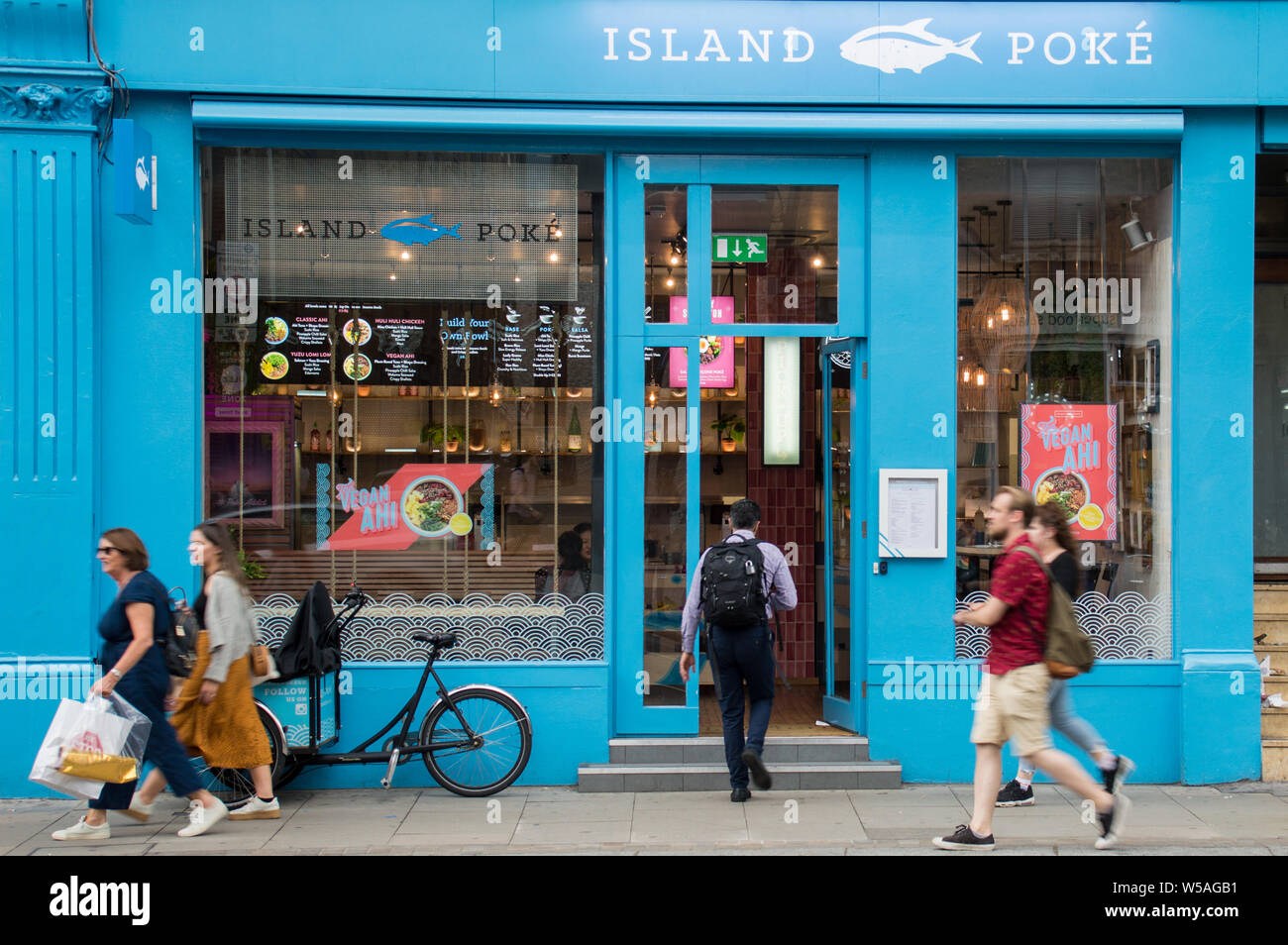 Man entering Island Poke food outlet in London shoreditch area Stock Photo
