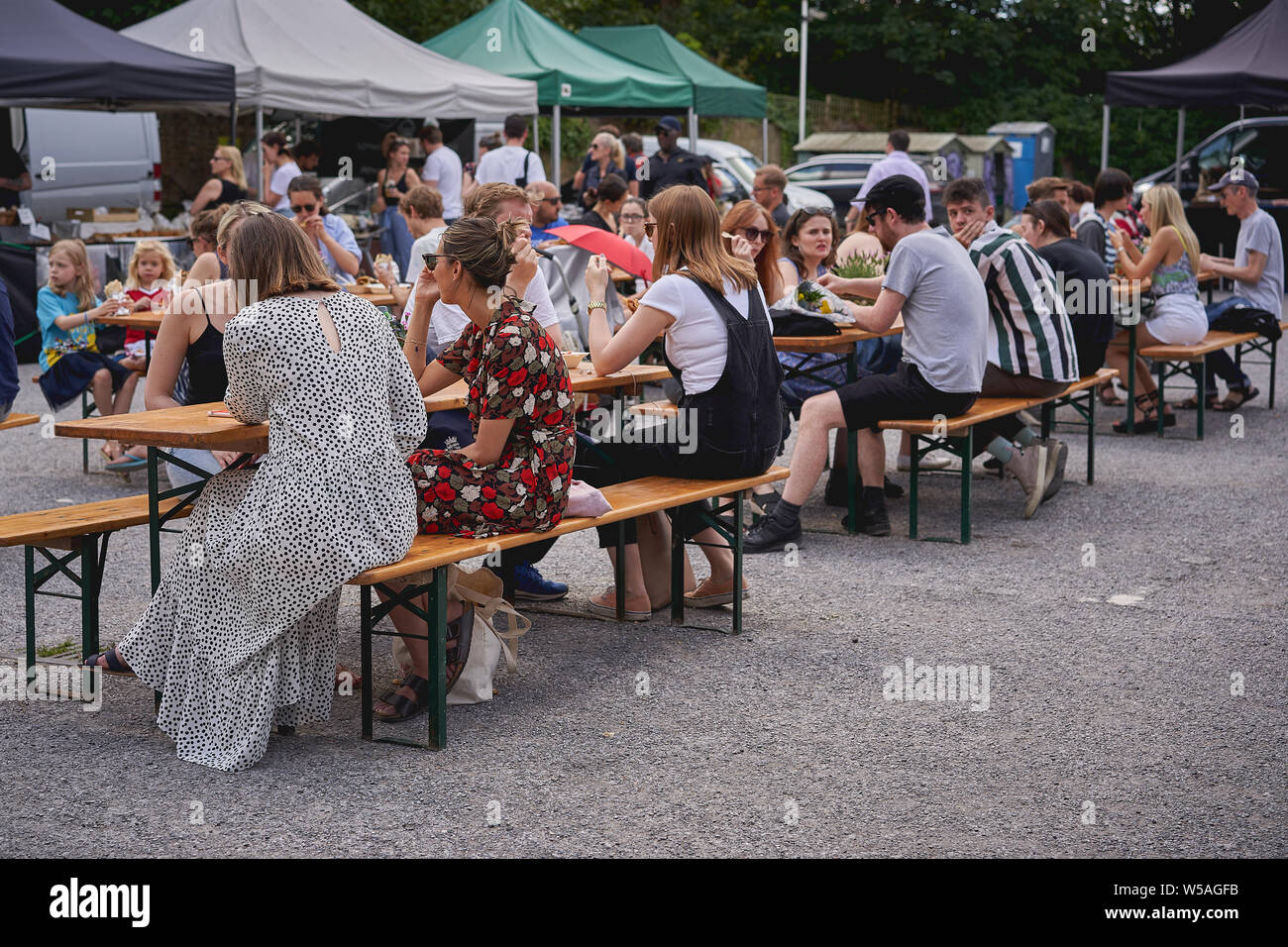 London, UK - July, 2019. People shopping and drinking at Brockley Market, a local farmer's market held every Saturday in Lewisham. Stock Photo