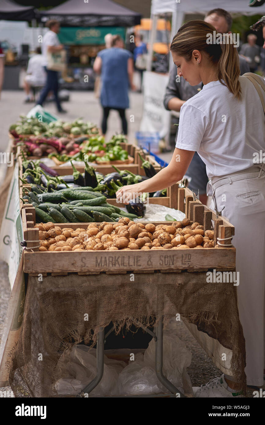 London, UK - July, 2019. Young people shopping organic vegetables in a local farmer's market in Brockley, South-East London. Stock Photo